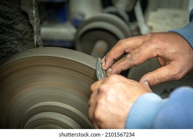 Isolated Close Up Of Chef Knife Sharpening, Honing And Stropping Process By  A Skilled Craftsman. Vintage Old School Craftsman At Work In Grange Shop Showing True Professional Skills.