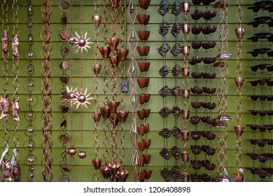 Isolated, Close Up View Of A Wall Of Decorative Rain Chains/rain Catchers
