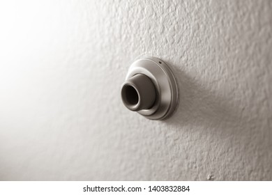 Isolated, close up of a wall mounted door stop, to prevent a door from damanging the wall when shut