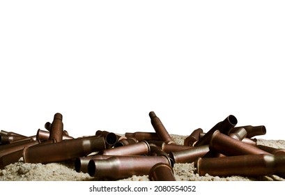 Isolated Close-up Photo Of Metal Bullet Gun Shells Laying On Sand Surface.