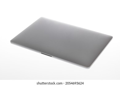 Isolated Closeup Studio Shot Of Close Cover Silver Metallic Wifi Wireless Digital Laptop Notebook Computer Mockup Working Technology Device For Text Copy Space Advertisement On White Background.