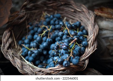 isolated clusters of grapes on wicker basket