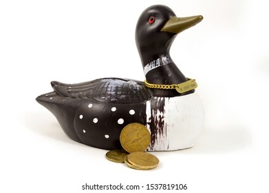 An Isolated Coin Bank Of The Loon That Is Represented On The Canadian One Dollar Coin Called The Loonie.