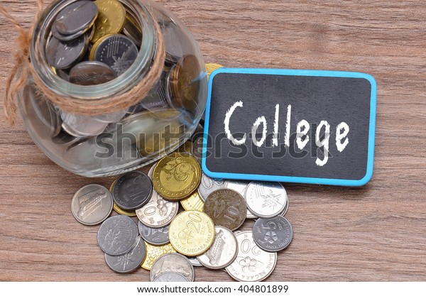Isolated coins in jar with College word on mini\
chalkboard - financial\
concept