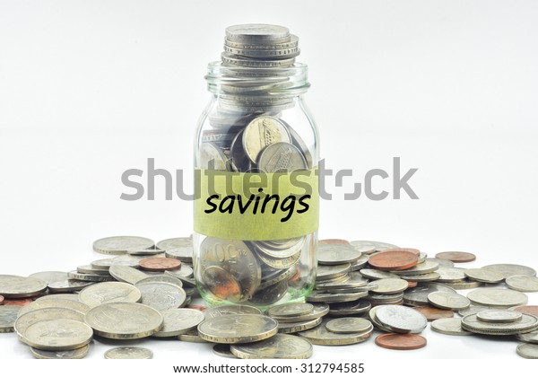 Isolated coins in jar with savings label -\
financial concept