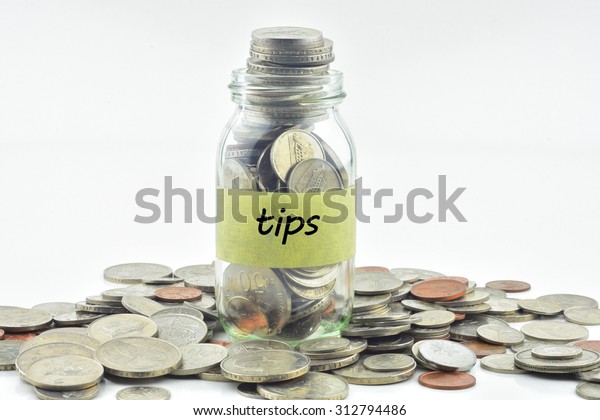 Isolated\
coins in jar with tips label - financial\
concept