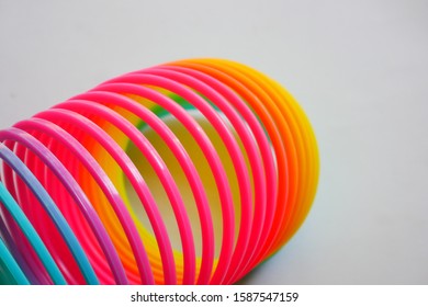 Isolated Colorful And Flexible Bouncy Plastic Spring.