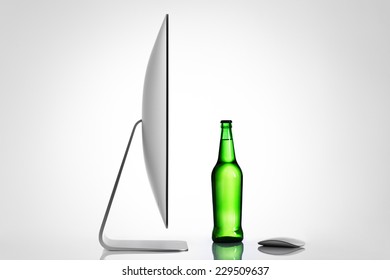 Isolated computer and beer bottle on a white background