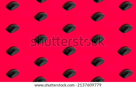 Isolated computer mouse on red background with hard shadow. Watermelon slice concept