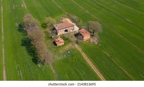 An isolated country house in a cultivated field in Emilia Romagna, Italy.