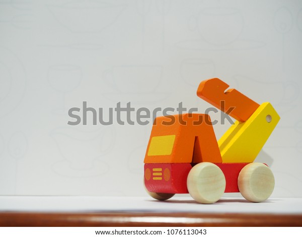 Isolated crane vehicle toy on white\
background. Space areas for copy text, message and\
quote.