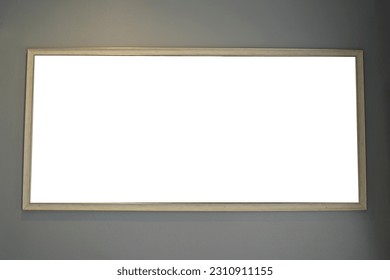 isolated cream wooden photo frame on white background Hang it on the gray wall. soft and selective focus.                        - Shutterstock ID 2310911155