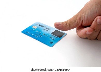 Isolated credit card and male finger touching biometric sensor. Biometric verification on credit card. User must have finger over the sensor when making a purchase. Fingerprint scanner. Safe payment