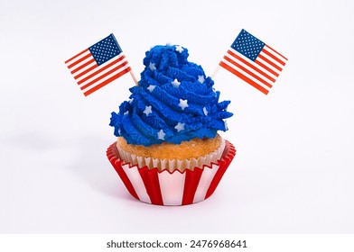 Isolated cupcake with "Old Glory Blue"color frosting topping with small stars and USA flags. An American celebration concept - Powered by Shutterstock