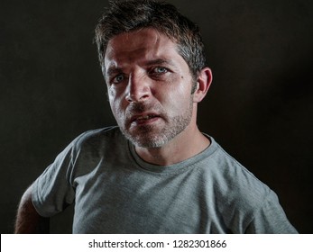 Isolated Dark Background Portrait Of Young Upset And Defiant Man In Arrogant And Cocky Pose Looking With Contempt And Inquisitive Stare In Disgust Emotion Face Expression 