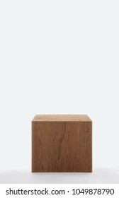 Isolated dark solid wood cube on white background and huge copyspace 