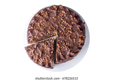 Isolated Delicious Chocolate Layered Cake With Nougat And Sponge Cake In The Cut On The Plate, Top View