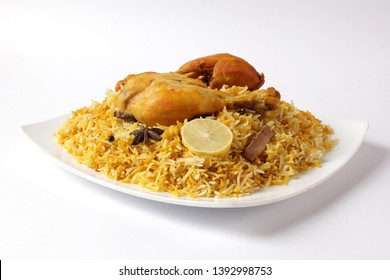 Isolated delicious spicy chicken biryani in white bowl on white background, Indian or Pakistani ramzan food. Beautiful view of traditional spicy indian food, Iftar meal, Ramadan dinner.