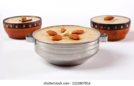 Isolated Eid Food, Indian Or Pakistani Kheer With Golden Foil Wrapped Chocolate Balls, Traditional Sweet Dessert. Iftar Meal, Diwali Party, Christmas Celebration.