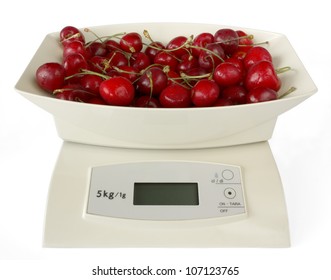 Isolated electronic kitchen weighing scales with cherries