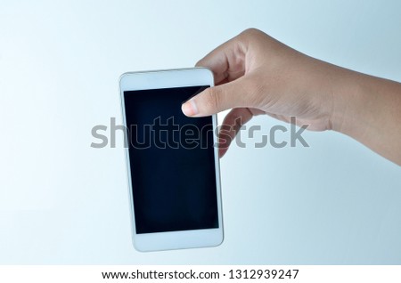 isolated famale hands holding the phone in grey background