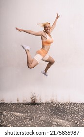 Isolated Female Athlete Jumping Outdoors
