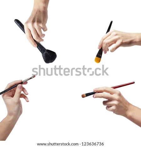 isolated female hands with a brushes for makeup