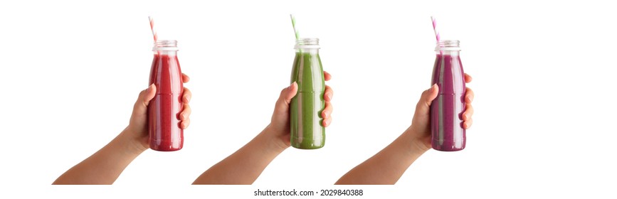 Isolated female hands holding a bottle with red, green and purple smoothies - Powered by Shutterstock