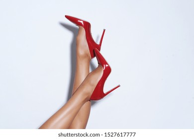 Isolated Female Legs In Red High Heels. Studio Shoot.