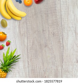 Isolated flat top view of different types of fruits on a wooden background with copy space. Concept of healthy, organic, nutrition and fresh. Fruits background, backdrop or banner.