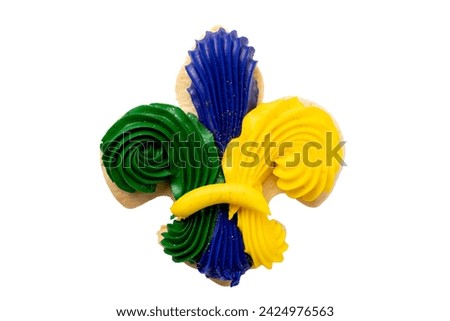 Isolated fleur de lis vanilla mardi gras cookie with green, purple and yellow icing.