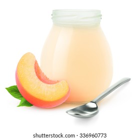 Isolated fruit yogurt. Glass jar of peach or apricot yogurt and slice of fruit isolated on white background with clipping path