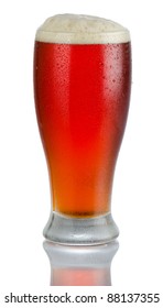 Isolated Full Length Portrait Of A Full Cold Beer In Tumbler Style Glass With Head Above Rim Level And Partial Reflection