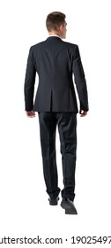 Isolated full length portrait of young businessman walking forward. Rear view.
