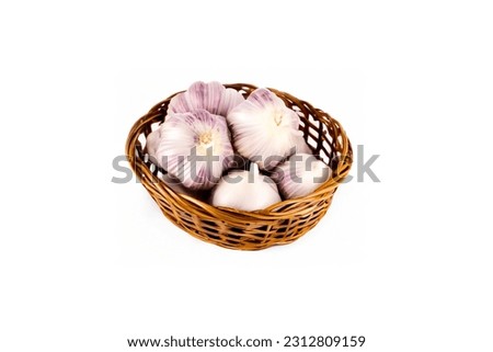 isolated garlic in a basket in white background