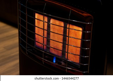 An Isolated Gas Heater On A Freezing Cold Winter Night Burning At Full Capacity, Glowing Orange And Radiating Heat.