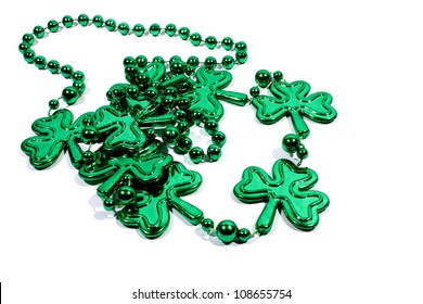 Isolated Green Mardi Gras Necklace With Three Leaf Clovers.