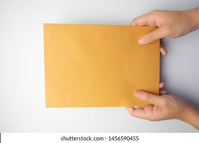Isolated hand send (submit or put) brown letters (mail, document, notation, note or paper)