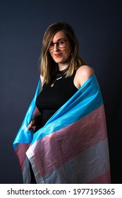 
Isolated Happy Transgender Woman Posing Smiling With LGTB Glag Trans Blue And Pink In Grey Background