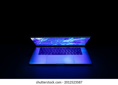 Isolated High Tech Open Laptop With Abstract Vibrant Color Screen On A Dark Background.