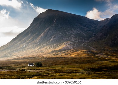 Isolated House Surrounded By Mountains In The Scottish Highlands