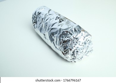 Isolated Image Burrito Wrap In Aluminium Foil.