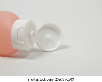 isolated image of close up of soft colored squeeze bottle with its cap open