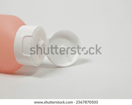 isolated image of close up of soft colored squeeze bottle with its cap open