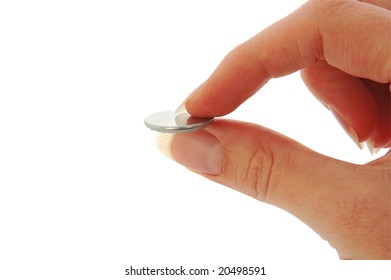 An isolated image of a tiny CR2025 watch battery pinched between fingers