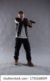 Isolated Image Of A White Male Wearing A Black Leather Jacket, Carrying A Gun, Ideal For Action Thriller Book Cover Design.