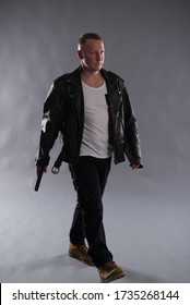 Isolated Image Of A White Male Wearing A Black Leather Jacket, Carrying A Gun, Ideal For Action Thriller Book Cover Design.