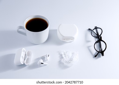 Isolated Invisible Aligner Braces Composed With Laptop, Coffee, And Ear Phones Concept.