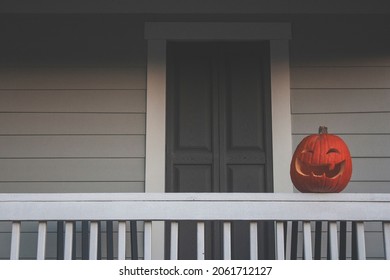 Isolated Jack O'Lantern On Porch Railing