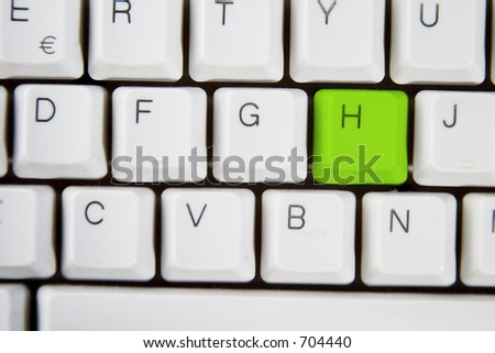 Isolated letter H on from a computer desktop keyboard highlighted in green
